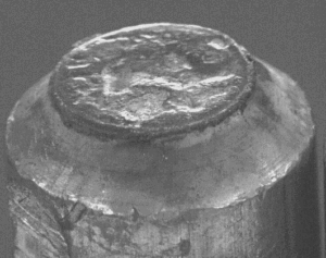 Closeup photo of a badly pitted electrode tip face