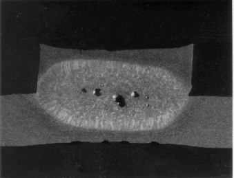 closeup photo of Holes at the center of the weld nugget revealed by sectioning (after teardown).